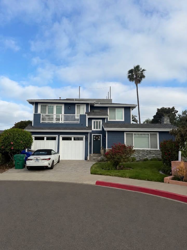 Two-story home exterior repaint after